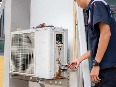 HVAC Tech Performing Summer HVAC Maintenance